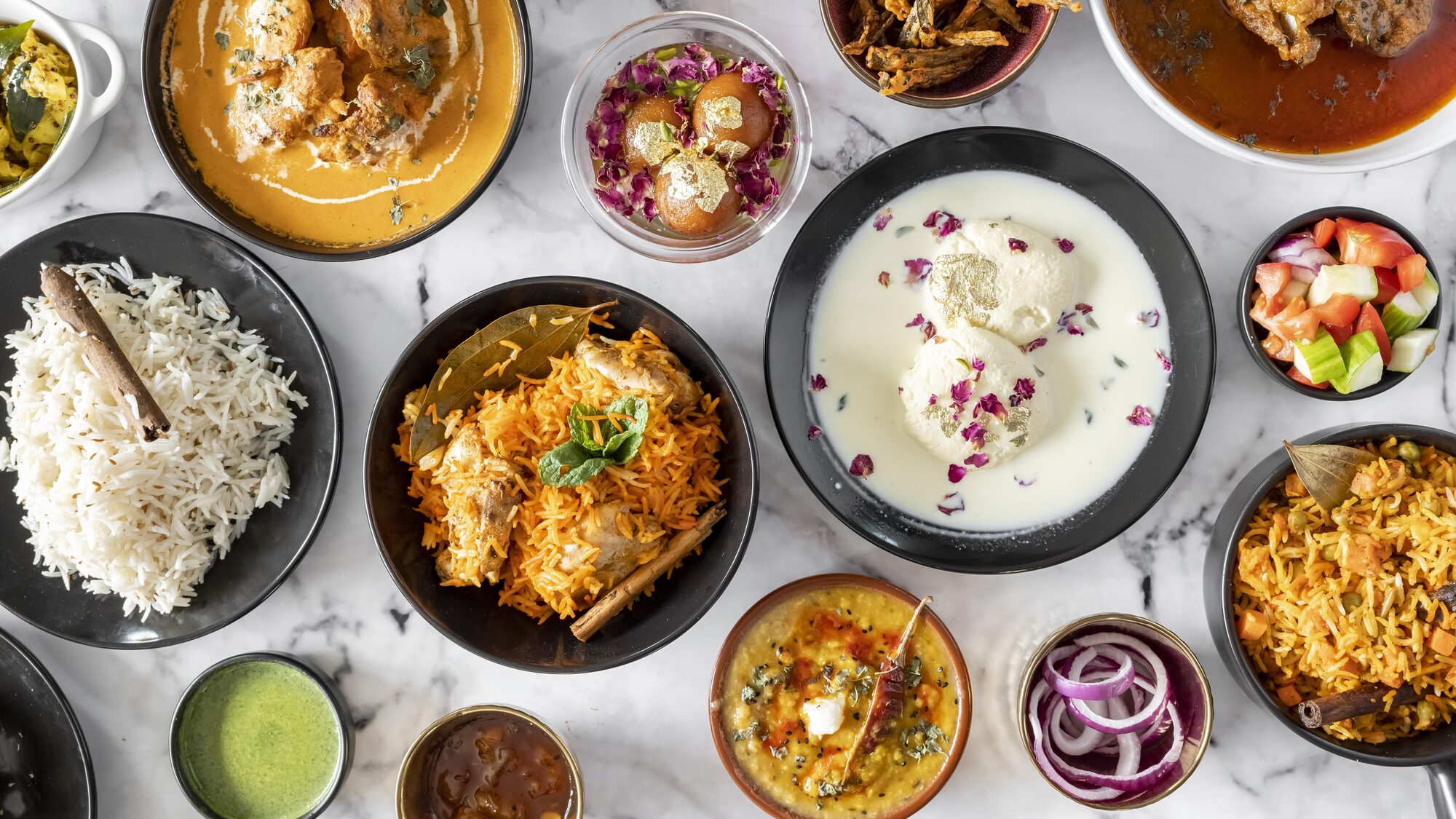 Indian home-cooked family spread by Chef Sakshi Ahluwalia — chicken biryani, rasmalai, dal and jeera rice from Saakshi's Kitchen