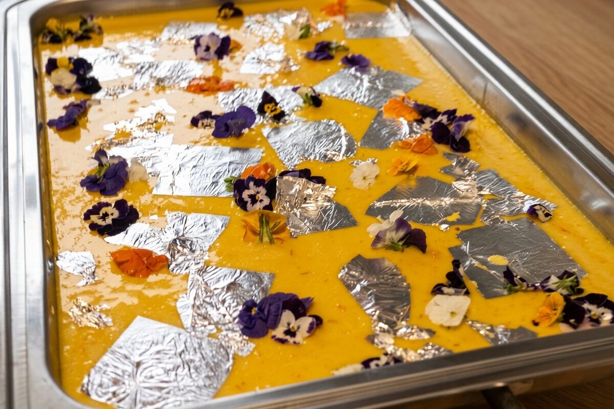 Saffron kheer decorated with silver vark and edible violets for a special occasion by Chef Sakshi Ahluwalia